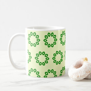 Green leaves in a circle on yellow  coffee mug