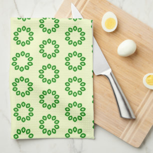 Green leaves in a circle on yellow tea towel