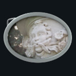 Green Man Oval Belt Buckle<br><div class="desc">The face with vines and flowers protruding from his mouth is known as a Green Man. In this colour photograph, the high relief sculpture is an architectural element that is part of a large planter atop a column. Shallow depth of field highlights the sculpture. Bokeh, out of focus circles of...</div>