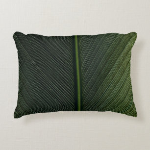 Green metal rod on black and white pinstripe texti decorative cushion
