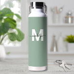Green Modern Name Monogram Water Bottle<br><div class="desc">Create Your Own Personalised Sage Green Name Monogram Water Bottle. This cute and stylish water bottle features a soft sage green background for an earthy, calming vibe. A bold white initial sits in the centre, overlaid by a flowing black script name for a personalised touch on both sides. Ideal for...</div>