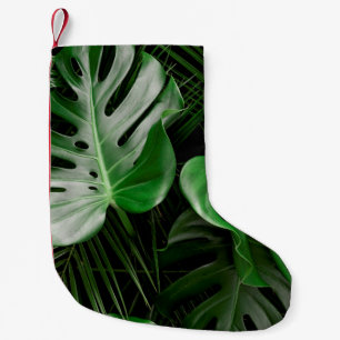 Green monstera leaves and palm leaves small christmas stocking