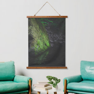 Green mossy rock with reflection in water hanging tapestry
