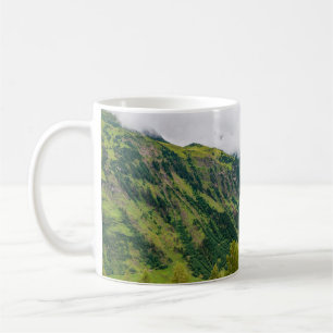 Green mountains covered with forest and green gras coffee mug