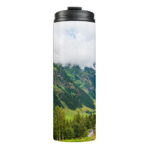Green mountains covered with forest and green gras thermal tumbler