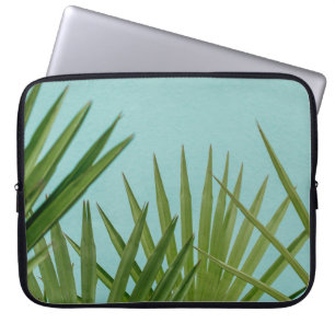 Green palm plant near body of water laptop sleeve