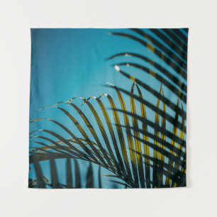 Green palm plant under blue sky in the morning tapestry
