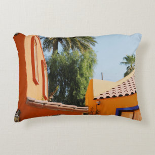 Green palm tree beside brown concrete building in  decorative cushion