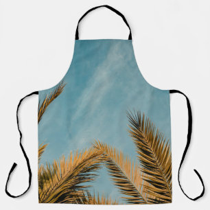 Green palm tree under blue sky in the morning apron