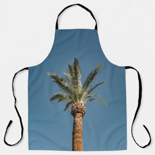 Green palm tree under blue sky in the morning apron