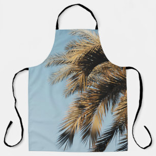 Green palm tree under blue sky in the morning apron