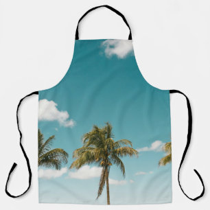 Green palm tree under blue sky in the morning apron