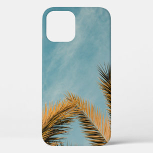 Green palm tree under blue sky in the morning iPhone 12 case