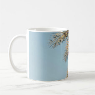 Green palm tree under blue sky in the morning coffee mug