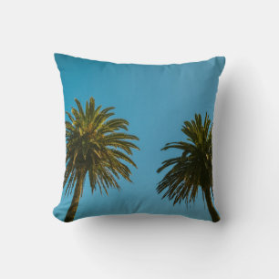 Green palm tree under blue sky in the morning cushion