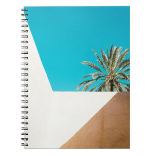 Green palm tree under blue sky in the morning notebook