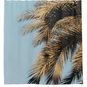 Green palm tree under blue sky in the morning shower curtain