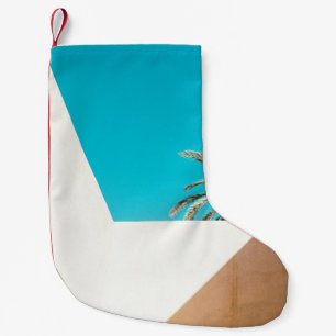 Green palm tree under blue sky in the morning small christmas stocking