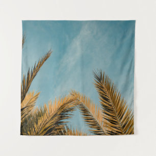 Green palm tree under blue sky in the morning tapestry