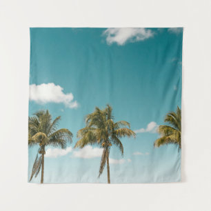 Green palm tree under blue sky in the morning tapestry