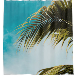 Green palm tree under blue sky shower curtain