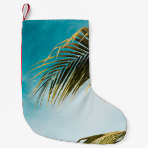 Green palm tree under blue sky small christmas stocking