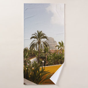 Green palm trees near brown concrete building in t bath towel