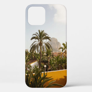Green palm trees near brown concrete building in t iPhone 12 case