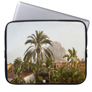 Green palm trees near brown concrete building in t laptop sleeve