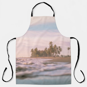 GREEN PALM TREES ON BROWN SAND UNDER WHITE CLOUDS APRON