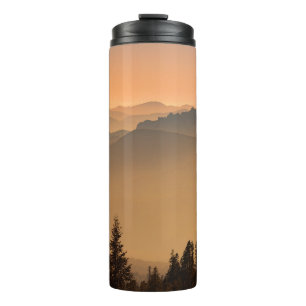 GREEN PINE TREES ON MOUNTAIN DURING DAYTIME THERMAL TUMBLER