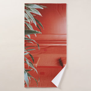 Green plant on red couch bath towel