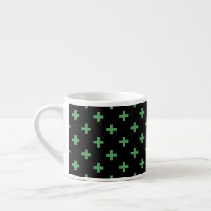 Green polka crosses on black espresso cup
