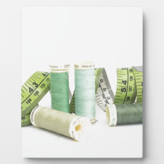 Green sewing kit and threads plaque