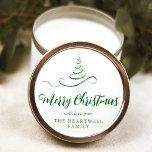 Green Silver Ribbon Tree Merry Christmas Script Classic Round Sticker<br><div class="desc">This modern holiday sticker features a green and silver faux foil ribbon Christmas tree sprinkled with silver faux glitter,  and the words "Merry Christmas" in stylish green calligraphy script. Personalise it with your family's name in serif font.</div>