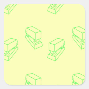 Green stapler on yellow square sticker