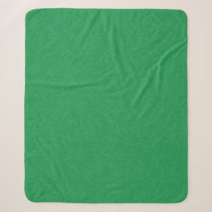 Green textured surface with swirling pattern sherpa blanket