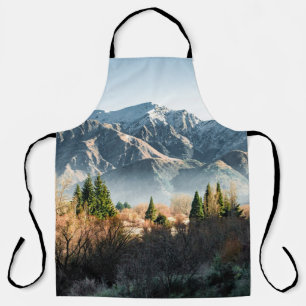 GREEN TREES NEAR SNOW COVERED MOUNTAIN DURING DAYT APRON