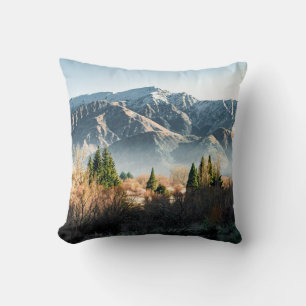 GREEN TREES NEAR SNOW COVERED MOUNTAIN DURING DAYT CUSHION