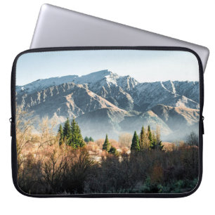 GREEN TREES NEAR SNOW COVERED MOUNTAIN DURING DAYT LAPTOP SLEEVE