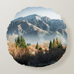 GREEN TREES NEAR SNOW COVERED MOUNTAIN DURING DAYT ROUND CUSHION