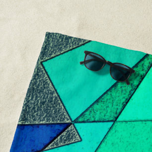 Green triangular cutouts on blue background, rough beach towel