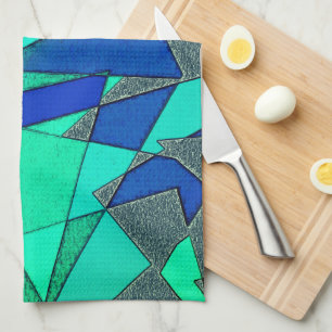 Green triangular cutouts on blue background, rough tea towel