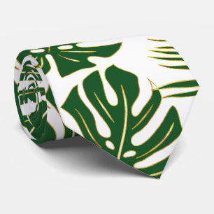 Green tropical monstera and palm leaves tie
