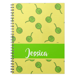 Green wool rolls on yellow notebook