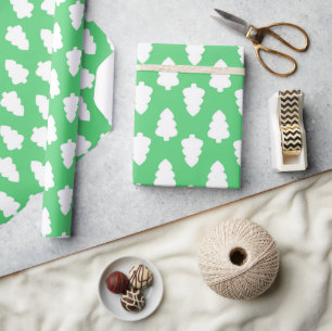 green wrapping paper with white christmas tree