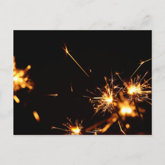 Greeting card with firework sparkles over black