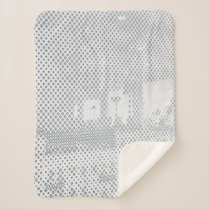 Grey and white chequered textile sherpa blanket