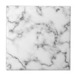 Grey and white Marble effect tile<br><div class="desc">This tile features a refined white marble design highlighted by soft grey veining. The natural marble pattern offers subtle detail and a clean, classic look that enhances both modern and traditional spaces. With a smooth, glossy finish, the tile is durable and easy to maintain—making it suitable for kitchen backsplashes, bathroom...</div>