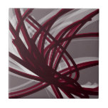 Grey & Burgundy Abstract Ribbons Ceramic Tile<br><div class="desc">Modern artistic design featuring burgundy wine coloured ribbons with white accents on a grey background. Designed with vector graphics, you can create your own customised throw pillow by changing the background and border colours. To create your personalised design, select “customise” and navigate to the layers section to view the images...</div>
